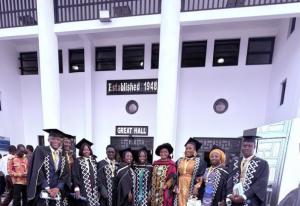 Ten graduate students in graduation gowns